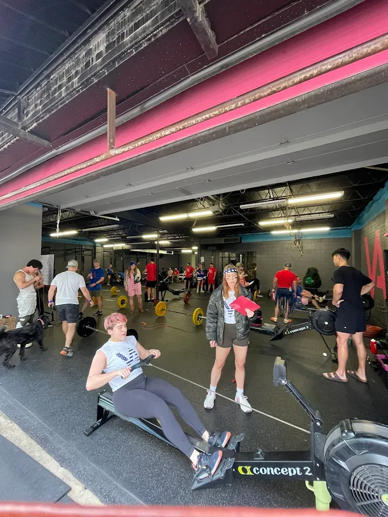 Group fitness class training on barbells and rowers at Vickery Athletics in East Dallas